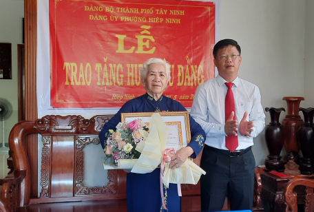 Ông Lê Minh Thế-Ủy viên Ban Thường vụ Tỉnh ủy- Bí thư Thành ủy Tây Ninh trao huy hiệu cho đảng viên Nguyễn Thị Phượng